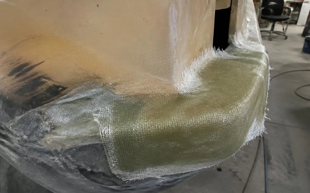 Fibreglass matting and resin laid over a damaged vehicle panel mid-repair — TKM Smash Repairs, Edmonton QLD